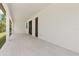 Large, covered patio with tiled floors and a view of the backyard at 3157 Bay City Ter, North Port, FL 34286