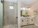 Spa-like bathroom with double vanity and a walk-in shower at 934 E Venice Ave, Venice, FL 34285