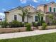 Tan house with brown roof, black fence, and palm trees in front at 938 E Venice Ave, Venice, FL 34285