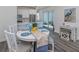 Bright dining area with round table and chairs, adjacent to kitchen at 189 Clifton Way, Venice, FL 34292