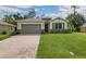 New construction home with a brick facade and a large driveway at 1508 Atwater Dr, North Port, FL 34288