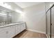 Double vanity bathroom with granite countertops and large mirror at 1508 Atwater Dr, North Port, FL 34288