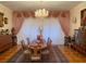 Elegant formal dining room featuring a large table, chandelier, and hardwood floors at 12209 Cotorro Ave, North Port, FL 34287