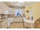 Kitchen with breakfast nook and white appliances at 12209 Cotorro Ave, North Port, FL 34287