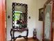 Elegant entryway with a large mirror and ornate console table at 12209 Cotorro Ave, North Port, FL 34287