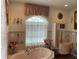 Bathroom with pink bathtub and vanity at 12209 Cotorro Ave, North Port, FL 34287