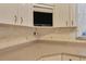 Kitchen detail showing built-in TV above counter space at 12209 Cotorro Ave, North Port, FL 34287