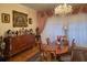 Elegant formal dining room featuring a large table, chandelier, and hardwood floors at 12209 Cotorro Ave, North Port, FL 34287