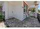 Front entry of villa with seating area and landscaping at 117 Clifton Way, Venice, FL 34292