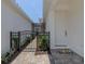 Side yard with gate and pathway leading to the house at 117 Clifton Way, Venice, FL 34292