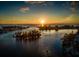 Scenic sunset over calm waters and houses at 117 Clifton Way, Venice, FL 34292