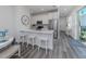 Modern kitchen with stainless steel appliances and breakfast bar at 117 Clifton Way, Venice, FL 34292