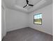 Bright bedroom with large window and grey tile flooring at 1729 Lugano Cir, Nokomis, FL 34275