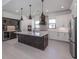 Modern kitchen with large island, custom cabinetry, and high-end finishes at 1729 Lugano Cir, Nokomis, FL 34275