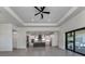 Open concept kitchen with large island, stainless steel appliances, and sliding doors to backyard at 1729 Lugano Cir, Nokomis, FL 34275