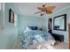 Bedroom with a ceiling fan and blue bedding at 1255 Tarpon Center Dr. # 505, Venice, FL 34285