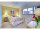Charming bedroom with floral bedding, natural light, and a serene atmosphere for relaxation at 244 Saint Augustine Ave # 203, Venice, FL 34285