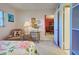 Bedroom with floral bedding, armchair, and workspace at 244 Saint Augustine Ave # 203, Venice, FL 34285