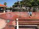 Fun splash pad area with children playing among the water fountains, surrounded by park benches and greenery at 244 Saint Augustine Ave # 203, Venice, FL 34285