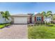 One-story home with a two-car garage and attractive landscaping at 1281 Cobble Glen Dr, Port Charlotte, FL 33953