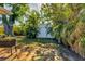 White storage shed nestled in a tropical backyard setting at 448 Redwood Rd, Venice, FL 34293