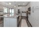 Modern kitchen with white cabinets, granite countertops, and stainless steel appliances at 922 E Venice Ave, Venice, FL 34285