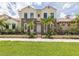 Two-story home with stone accents and lush landscaping at 922 E Venice Ave, Venice, FL 34285