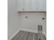 Laundry closet with white cabinets and vinyl flooring at 922 E Venice Ave, Venice, FL 34285