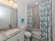 Clean bathroom with tub shower, granite vanity, and updated fixtures at 922 E Venice Ave, Venice, FL 34285
