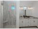 Spa-like bathroom with double vanity, large shower, and neutral tile at 922 E Venice Ave, Venice, FL 34285