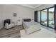 Main bedroom with plush bedding, access to private patio and pool at 922 E Venice Ave, Venice, FL 34285