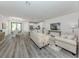 Open living room with hardwood floors, neutral color palette, and access to kitchen and dining area at 922 E Venice Ave, Venice, FL 34285
