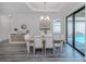 Bright dining room with pool view and modern chandelier at 922 E Venice Ave, Venice, FL 34285