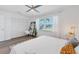 Bright bedroom with king bed, window, and built-in shelving at 18091 Eau Gallie Cir, Port Charlotte, FL 33948