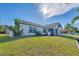 Newly renovated home with a large green lawn at 18091 Eau Gallie Cir, Port Charlotte, FL 33948