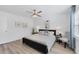 King-size bed, ceiling fan, and light flooring in this bright bedroom at 18091 Eau Gallie Cir, Port Charlotte, FL 33948