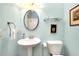 Small bathroom with pedestal sink and glass shelving at 11065 Barnsley Dr, Venice, FL 34293