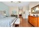 Main bedroom with wood floors, large bed and ensuite bathroom access at 11065 Barnsley Dr, Venice, FL 34293