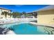 Relaxing community pool with surrounding lounge chairs at 101 Natures Way # 1104, Rotonda West, FL 33947