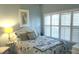 Guest bedroom with queen bed and large window with plantation shutters at 101 Natures Way # 1104, Rotonda West, FL 33947