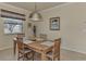 Dining area with wood table and chairs, neutral decor at 20625 Romagna Pl, Venice, FL 34293