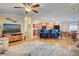 Open floor plan boasts a spacious kitchen with island and breakfast bar, seamlessly flowing into a comfortable living room at 3100 Goldfinch Ter, Englewood, FL 34224