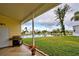 Relaxing covered patio overlooking the lake, complete with a grill at 3100 Goldfinch Ter, Englewood, FL 34224