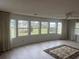 Bright living room featuring light wood floors, large windows, and a view of the outdoors at 517 Via Veneto, Venice, FL 34285