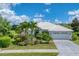 Single-Gathering home with white tile roof and landscaping at 177 Venice Palms Blvd, Venice, FL 34292