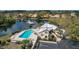 Aerial view of community pool, clubhouse, and lake at 218 Laurel Hollow Dr # 10, Nokomis, FL 34275