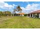 Large backyard with grassy area and home view at 218 Laurel Hollow Dr # 10, Nokomis, FL 34275