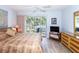 Main bedroom with balcony access and view of lush tropical foliage at 454 Cerromar Rd # 275, Venice, FL 34293