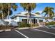 Community clubhouse with palm trees and ample parking at 454 Cerromar Rd # 275, Venice, FL 34293