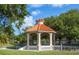 Accessible gazebo with a red tile roof, surrounded by lush landscaping at 454 Cerromar Rd # 275, Venice, FL 34293
